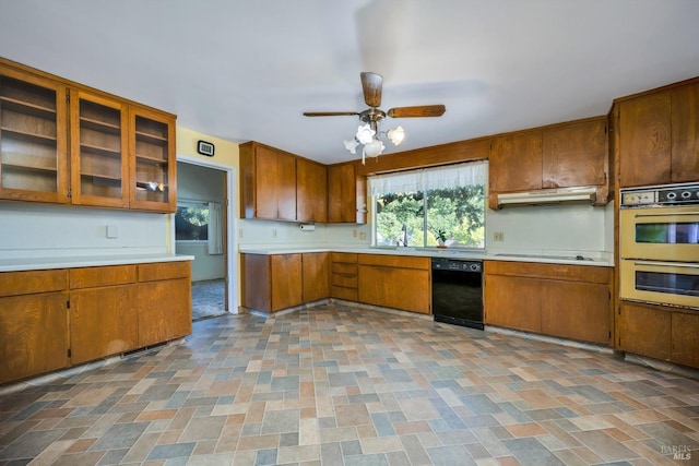 kitchen with sink, double wall oven, ceiling fan, black dishwasher, and stovetop