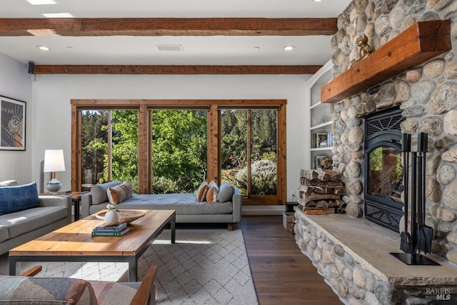 living room featuring built in features, beam ceiling, dark hardwood / wood-style flooring, and a fireplace