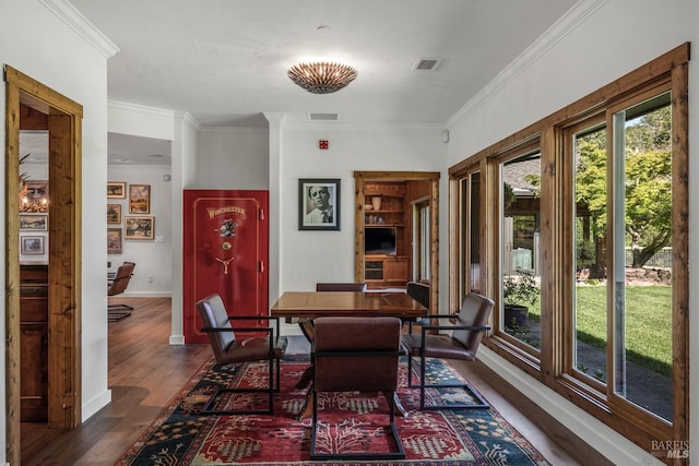 dining area featuring crown molding and dark wood-type flooring