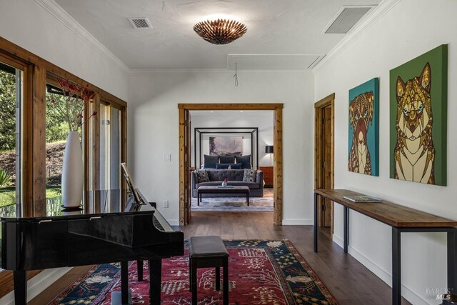 misc room with dark wood-type flooring and ornamental molding