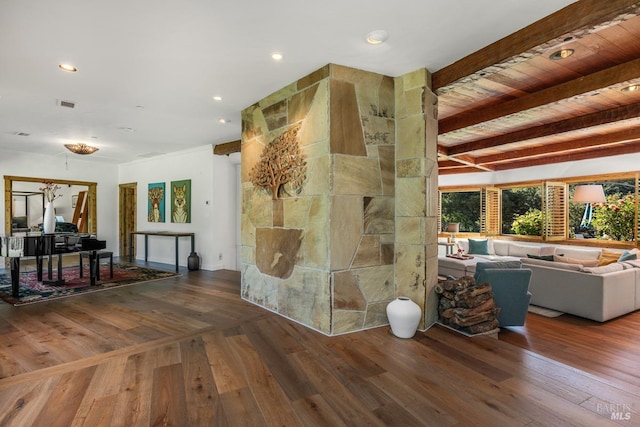 unfurnished living room featuring hardwood / wood-style flooring and beam ceiling