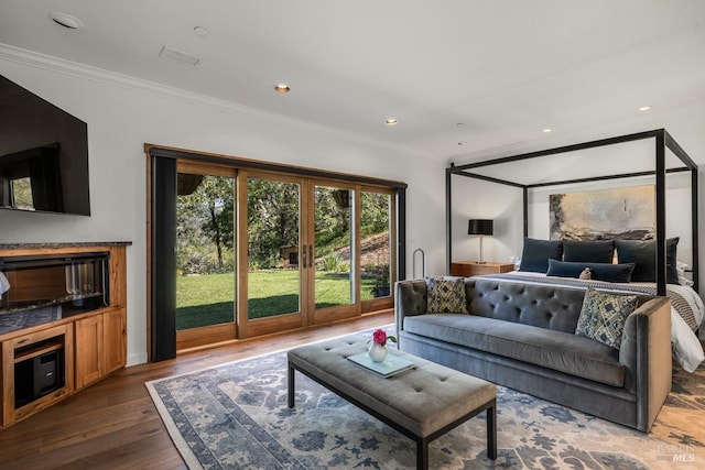 living room featuring french doors, hardwood / wood-style flooring, and ornamental molding