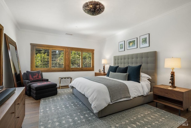 bedroom featuring hardwood / wood-style flooring and crown molding