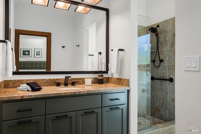 bathroom with vanity, a shower with door, and crown molding