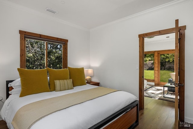 bedroom featuring dark wood-type flooring and ornamental molding