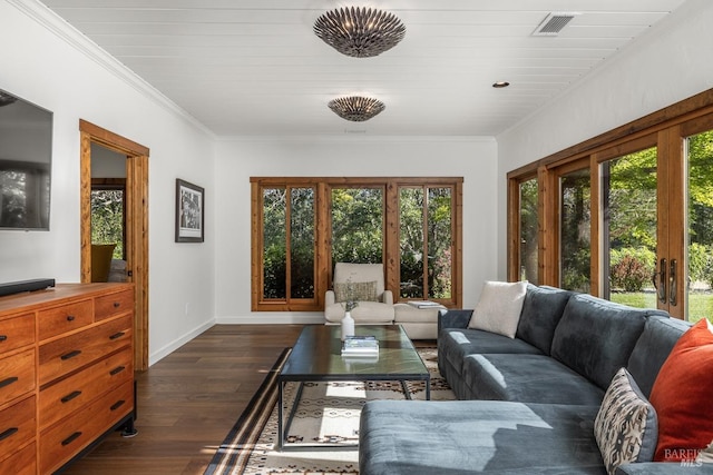 living room featuring dark wood-type flooring, ornamental molding, and plenty of natural light