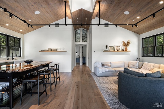 living room with wood ceiling, high vaulted ceiling, wood-type flooring, and track lighting