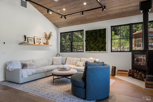 living room with wood ceiling, rail lighting, hardwood / wood-style flooring, and plenty of natural light