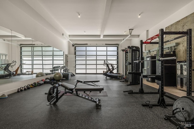 workout area with a towering ceiling