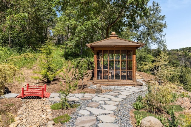 view of outdoor structure featuring a sunroom