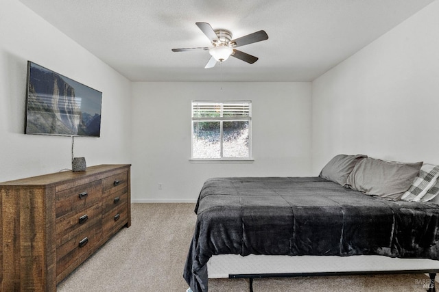 bedroom with ceiling fan and light carpet