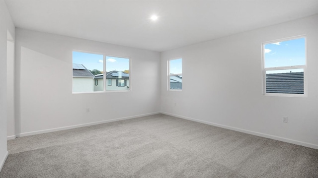 carpeted spare room with a healthy amount of sunlight