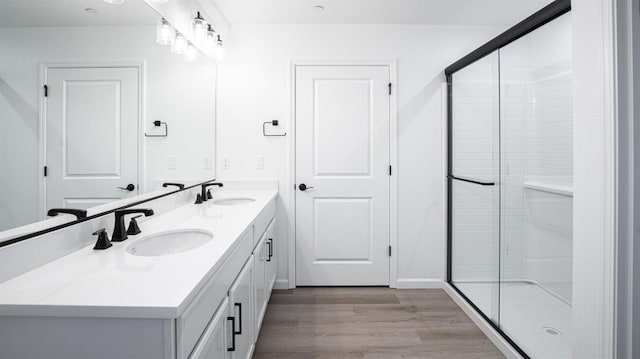 bathroom featuring vanity, wood-type flooring, and walk in shower