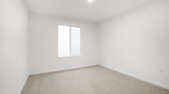 unfurnished room featuring carpet