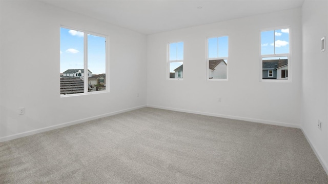 spare room with carpet flooring and a healthy amount of sunlight