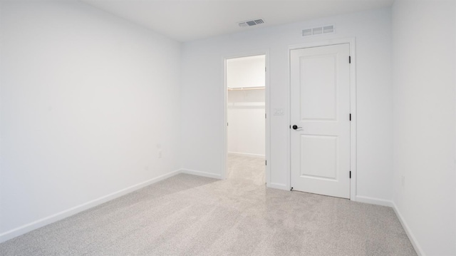 unfurnished room featuring light carpet