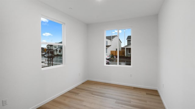 empty room with plenty of natural light and light wood-type flooring