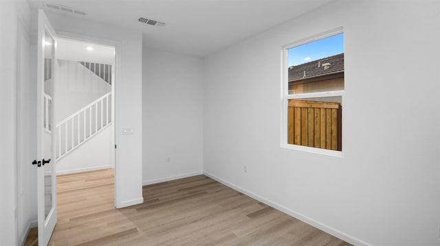 spare room with light hardwood / wood-style flooring