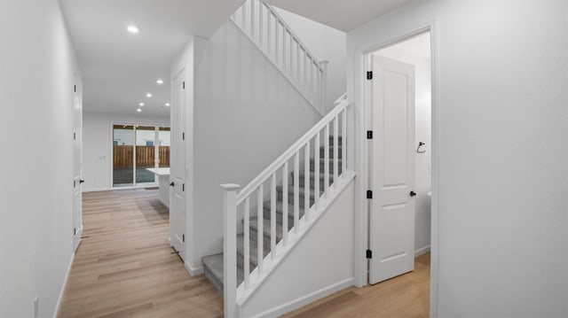 stairs featuring wood-type flooring