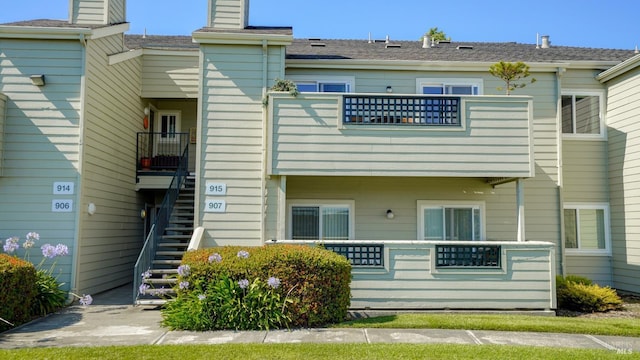 back of property featuring stairway