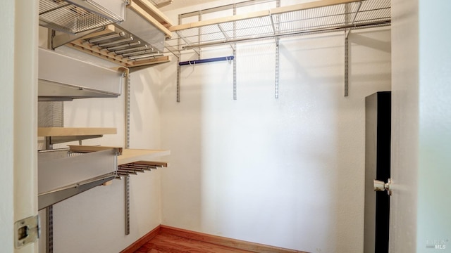 spacious closet with wood finished floors