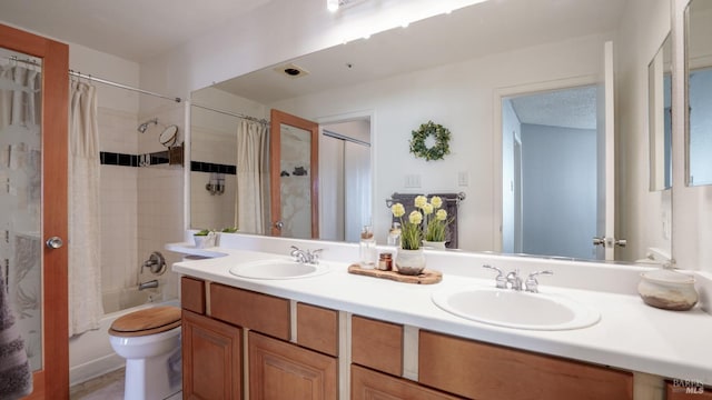 full bath featuring double vanity, toilet, shower / bath combo, and a sink