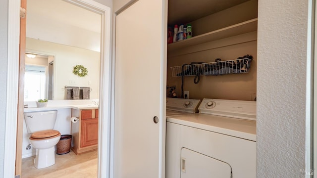 laundry area featuring laundry area, light tile patterned floors, and washing machine and dryer