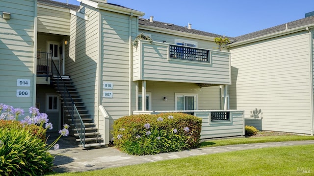 back of property featuring stairway