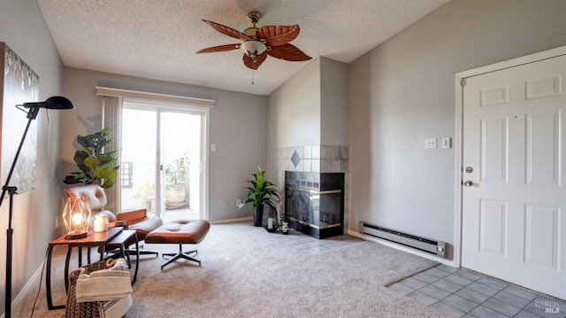 sitting room featuring vaulted ceiling, carpet floors, a fireplace, a textured ceiling, and a baseboard radiator