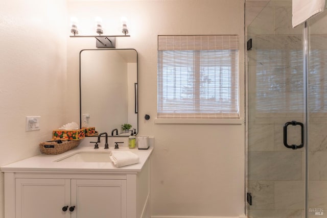 bathroom with vanity and a shower with shower door