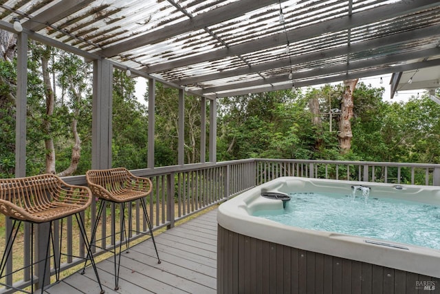 wooden terrace featuring a hot tub and a pergola