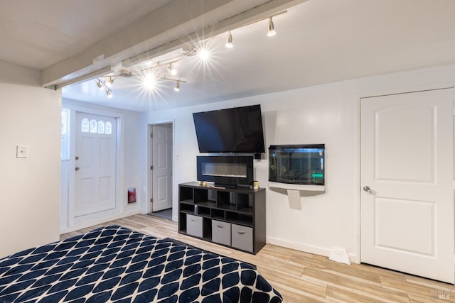 bedroom featuring track lighting and hardwood / wood-style flooring