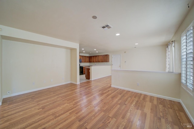 unfurnished living room with light hardwood / wood-style flooring