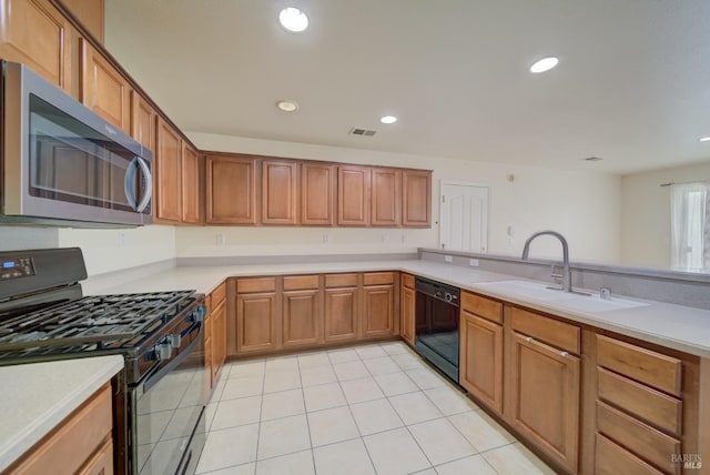 kitchen featuring light tile patterned floors, sink, and black appliances