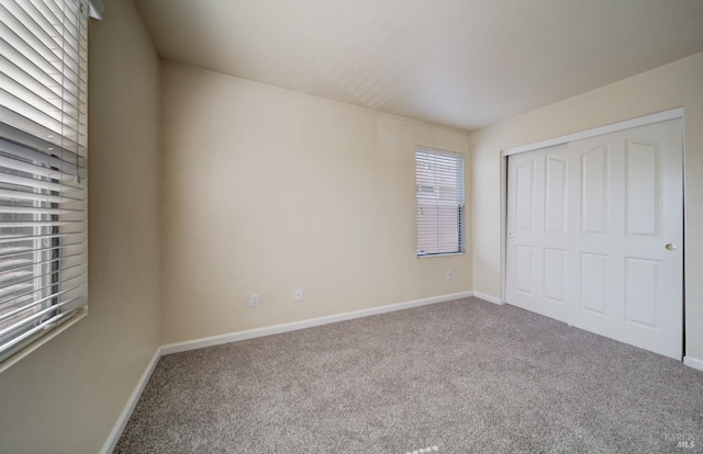 unfurnished bedroom with carpet and a closet