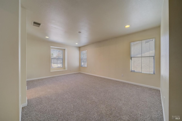 spare room featuring light colored carpet