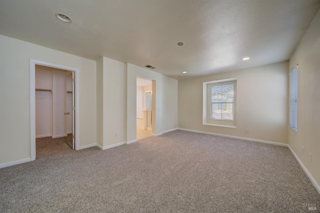 spare room featuring light colored carpet