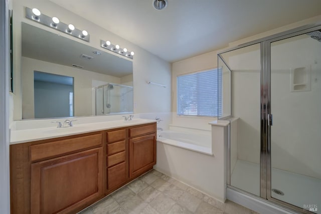 bathroom with vanity and independent shower and bath