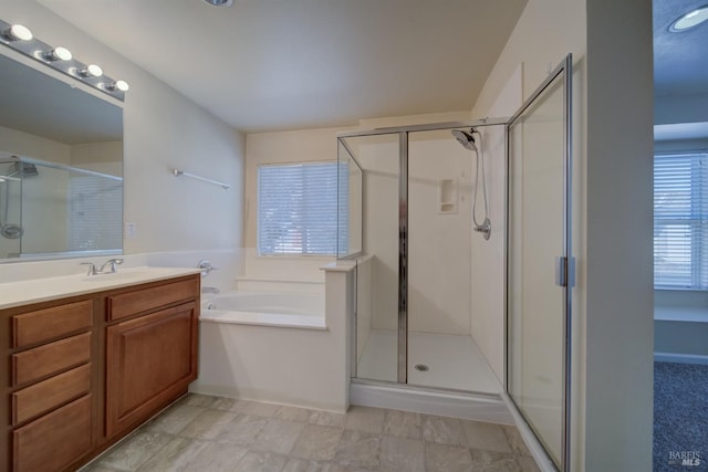 bathroom featuring separate shower and tub and vanity