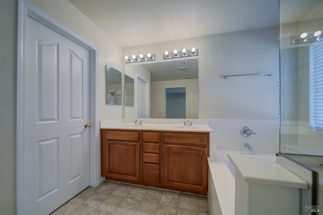 bathroom with vanity and a bath