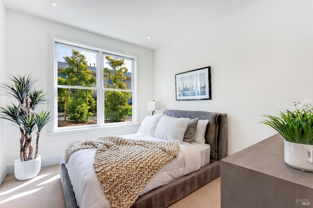 bedroom featuring light carpet