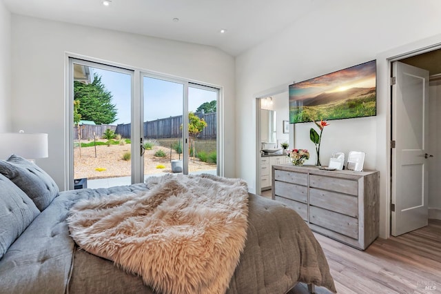 bedroom featuring access to exterior and light wood-type flooring