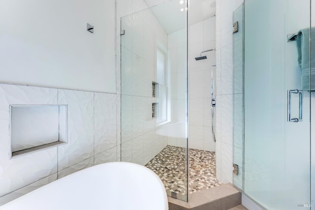 bathroom with independent shower and bath and tile walls