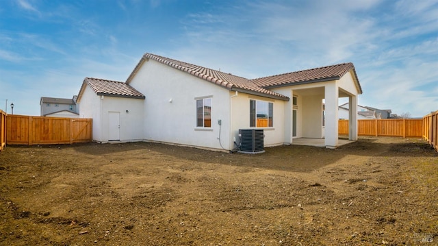 rear view of property with cooling unit