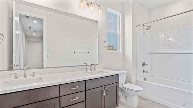 full bathroom with shower / tub combination, vanity, toilet, and hardwood / wood-style floors