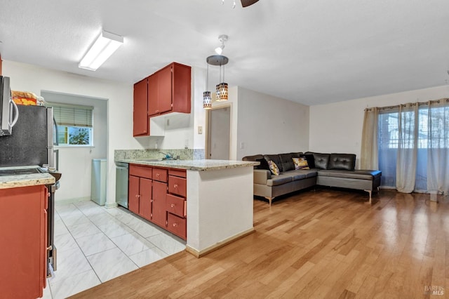 kitchen with ceiling fan, sink, stainless steel appliances, pendant lighting, and light hardwood / wood-style floors