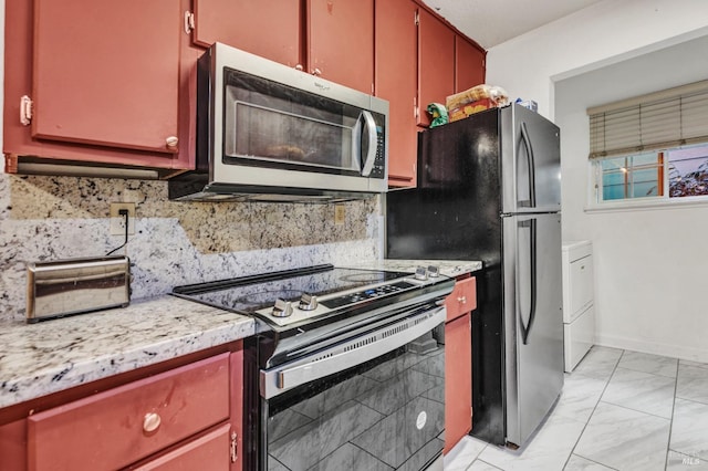 kitchen featuring tasteful backsplash and black electric range