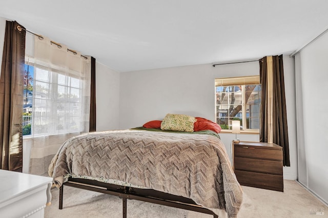 bedroom featuring light carpet