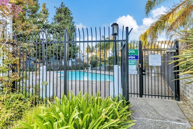 view of gate with a community pool