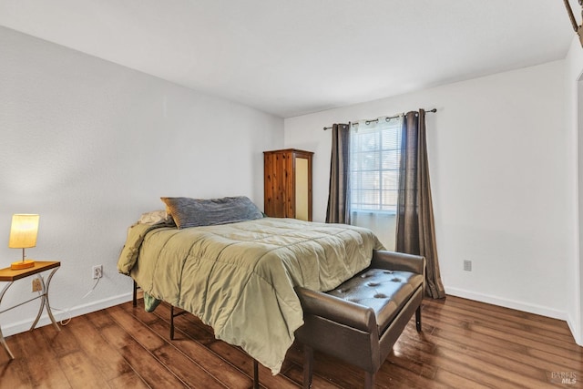 bedroom with dark wood-type flooring